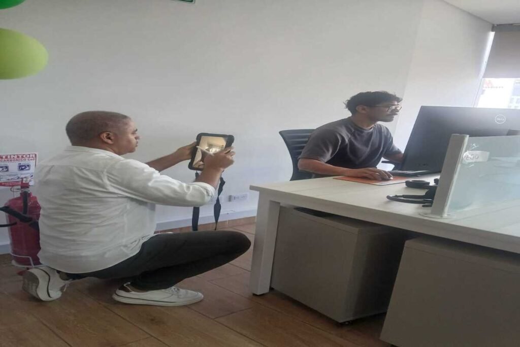 Consultor de SO&NSO realizando una evaluación ergonómica de puesto de trabajo en oficina para prevenir lesiones osteomusculares.